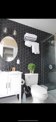 a bathroom with a toilet and a sink and a mirror at Fresh&Quiet one bedroom Apartment in University City near Drexel&UPenn in Philadelphia