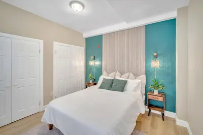 a bedroom with a white bed and blue walls at Huge 5 bedroom in Center City Philadelphia in Philadelphia