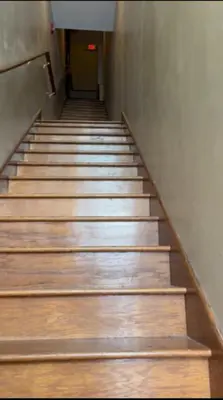 a stairway with wooden steps in a building at Huge 5 bedroom in Center City Philadelphia in Philadelphia
