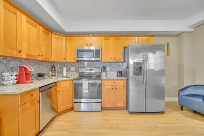 a kitchen with stainless steel appliances and wooden cabinets at Huge 5 bedroom in Center City Philadelphia in Philadelphia