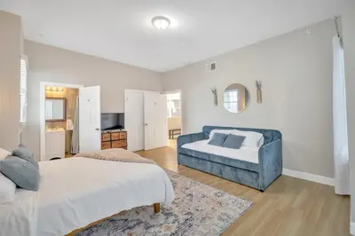 a white bedroom with a bed and a couch at Huge 5 bedroom in Center City Philadelphia in Philadelphia