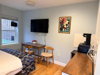 a bedroom with a bed and a desk with a computer at Sunny&Cozy Apartment in University City near Drexel&UPenn in Philadelphia