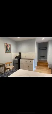 a living room with a kitchen and a dining room at Sunny&Cozy Apartment in University City near Drexel&UPenn in Philadelphia