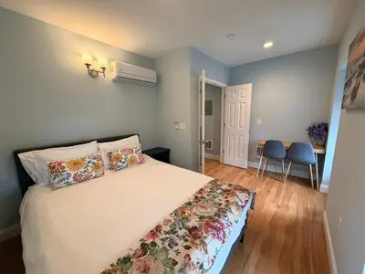 a bedroom with a bed and a table and chairs at Super Cozy two bedrooms Apartment in University City near Drexel&UPenn in Philadelphia