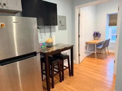 a kitchen with a stainless steel refrigerator and a table at Super Cozy two bedrooms Apartment in University City near Drexel&UPenn in Philadelphia