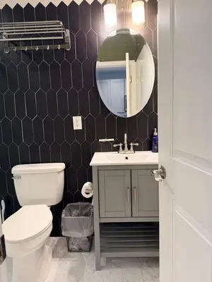 a bathroom with a toilet and a sink and a mirror at Super Cozy two bedrooms Apartment in University City near Drexel&UPenn in Philadelphia