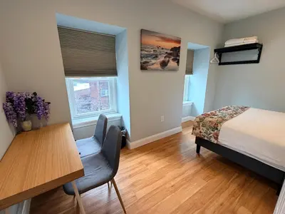 a bedroom with a bed and a desk and a table at Super Cozy two bedrooms Apartment in University City near Drexel&UPenn in Philadelphia