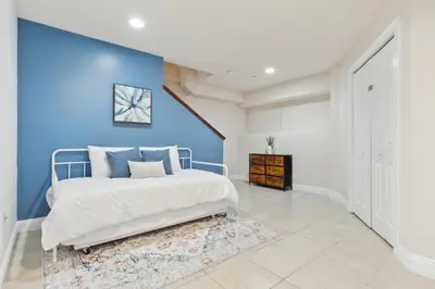 a bedroom with a blue accent wall and a bed at Cozy 3 bedroom in Center City Philadelphia in Philadelphia