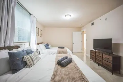 a large bedroom with two beds and a flat screen tv at Cozy 3 bedroom in Center City Philadelphia in Philadelphia