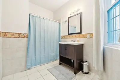 a bathroom with a sink and a shower with a mirror at Cozy 3 bedroom in Center City Philadelphia in Philadelphia