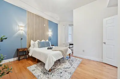 a bedroom with a bed and a blue wall at Cozy 3 bedroom in Center City Philadelphia in Philadelphia