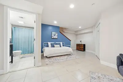 a bedroom with a bed and a blue wall at Cozy 3 bedroom in Center City Philadelphia in Philadelphia