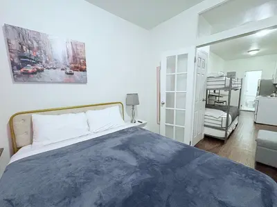 a bedroom with a bed with a blue blanket at The W50 Metropolitan in New York