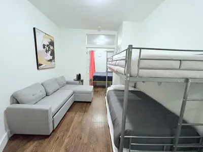 a living room with a couch and a bunk bed at The W50 Metropolitan in New York