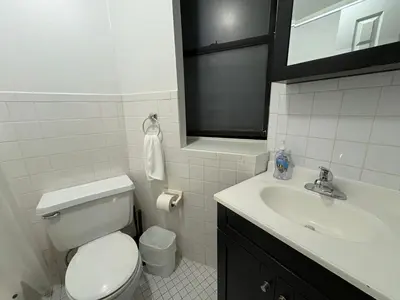 a white bathroom with a toilet and a sink at The W50 Metropolitan in New York