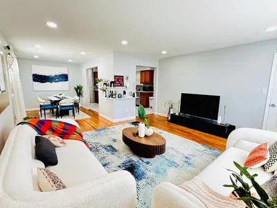 a living room with two white couches and a table at Lux NYC Stay 3Bed2Bath w parking in Jersey City