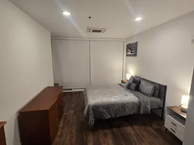 a bedroom with a bed and a dresser in it at Luxury Northern Liberties Living in Philadelphia