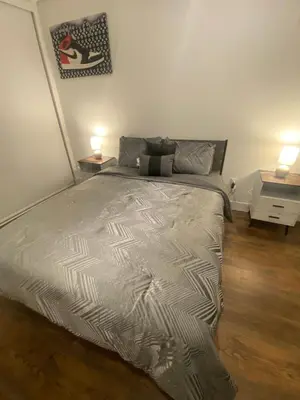 a large bed in a bedroom with two lamps at Luxury Northern Liberties Living in Philadelphia