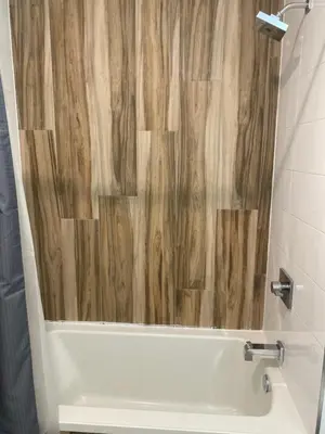 a bathroom with a tub with a wooden shower curtain at Luxury Northern Liberties Living in Philadelphia