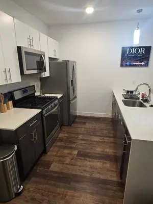 a kitchen with a sink and a stove top oven at Luxury Northern Liberties Living in Philadelphia