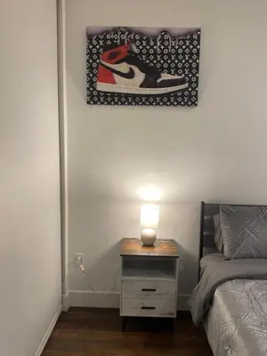 a bedroom with a bed and a table with a lamp at Luxury Northern Liberties Living in Philadelphia