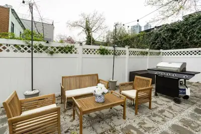 a patio with three chairs and a table and a grill at Chic 3BR-4BD-3Bath Oasis with Backyard Near NYC in Jersey City