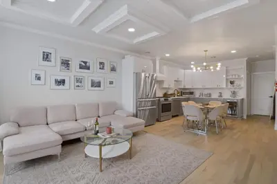a living room with a couch and a table at Elegant 2BR-2BA Spacious Escape with Rooftop Near NYC in Jersey City