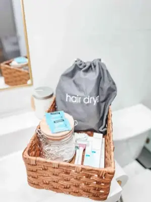 a wicker basket with a hair dryer and a bag at Elegant 2BR-2BA Spacious Escape with Rooftop Near NYC in Jersey City