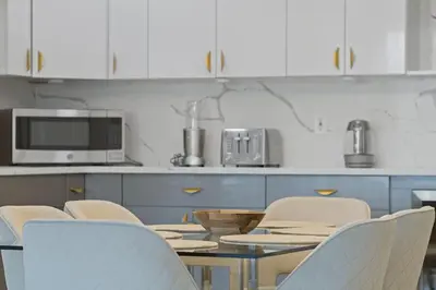 a kitchen with a table and chairs and a microwave at Elegant 2BR-2BA Spacious Escape with Rooftop Near NYC in Jersey City