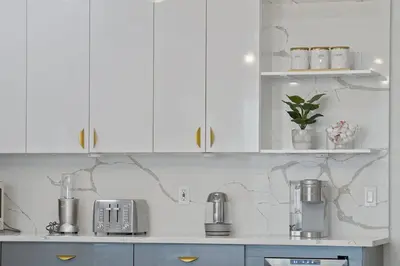 a kitchen with white cabinets and a counter top at Elegant 2BR-2BA Spacious Escape with Rooftop Near NYC in Jersey City