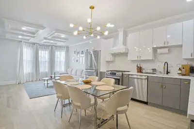 a kitchen and dining room with a table and chairs at Elegant 2BR-2BA Spacious Escape with Rooftop Near NYC in Jersey City