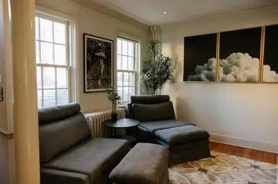 a living room with two chairs and a table at The Ashfield House - Close to Downtown Lancaster in Lancaster