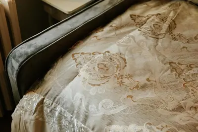 a close up of a white bedsheet with flowers on it at The Ashfield House - Close to Downtown Lancaster in Lancaster