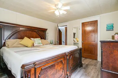 a bedroom with a wooden bed with a ceiling fan at Close to Venues and Fairgrounds! York Area Home in Red Lion