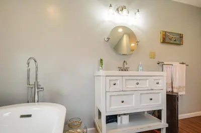 a bathroom with a sink and a mirror at Close to Venues and Fairgrounds! York Area Home in Red Lion