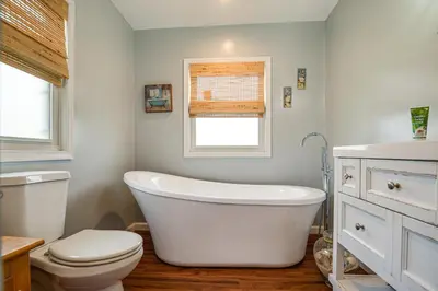 a bathroom with a tub and a toilet and a window at Close to Venues and Fairgrounds! York Area Home in Red Lion