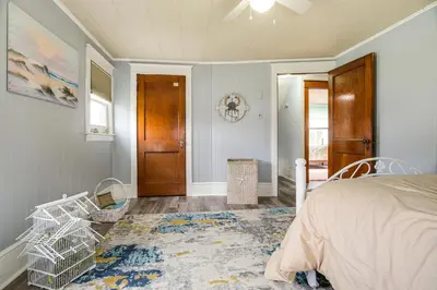 a bedroom with a bed and a hallway with a door at Close to Venues and Fairgrounds! York Area Home in Red Lion