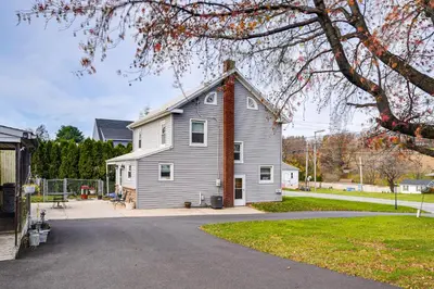 a white house with a chimney on top of it at Close to Venues and Fairgrounds! York Area Home in Red Lion