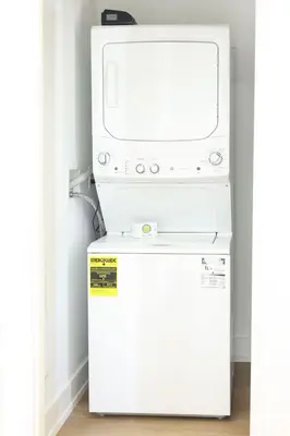 a microwave oven sitting on top of a refrigerator at Excellence by Urooms Apartments Near NYC and Newark Airport with Parking in Elizabeth