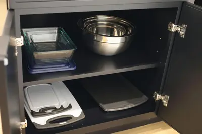 a cupboard with dishes and a bowl on top of it at Excellence by Urooms Apartments Near NYC and Newark Airport with Parking in Elizabeth