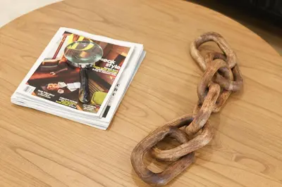 a piece of rope on a table next to a magazine at Excellence by Urooms Apartments Near NYC and Newark Airport with Parking in Elizabeth