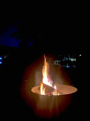 a large fire is burning in the dark at Lakefront House 30 Min to NYC & MetLife Stadium