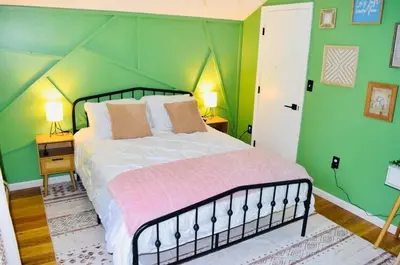 a bedroom with a bed with a green wall at LUX Poconos Home MINS to Lehigh Valley Hosp in Pocono Summit