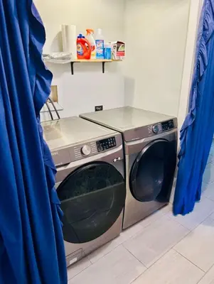a washing machine in a kitchen with blue curtains at LUX Poconos Home MINS to Lehigh Valley Hosp in Pocono Summit