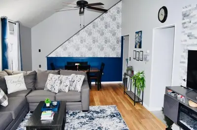 a living room with a couch and a table at LUX Poconos Home MINS to Lehigh Valley Hosp in Pocono Summit
