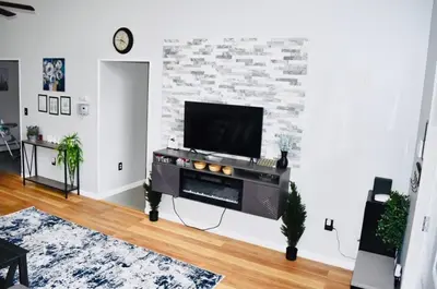a living room with a flat screen tv on a wall at LUX Poconos Home MINS to Lehigh Valley Hosp in Pocono Summit