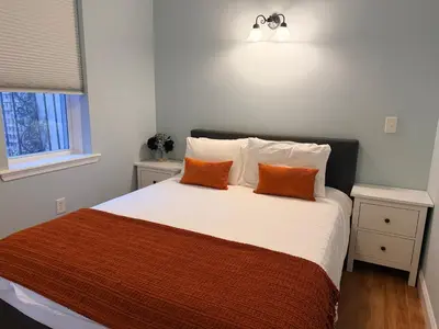 a bedroom with a bed with two orange pillows at Spacious one bedroom Apartment in University City near Drexel&UPenn in Philadelphia