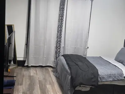 a bedroom with a bed and a window with curtains at FNR Suites, Washington Ave, Endicott, NY in Endicott