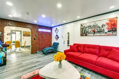 a living room with a red couch and a table at Walk to Shops, Parks and Restaurants Teaneck Escape in Teaneck