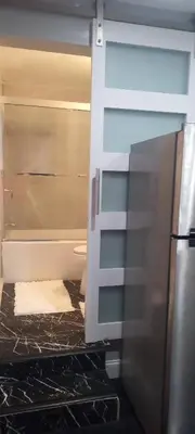 a kitchen with a refrigerator and a counter top at Nectar of the Gardens in Newark